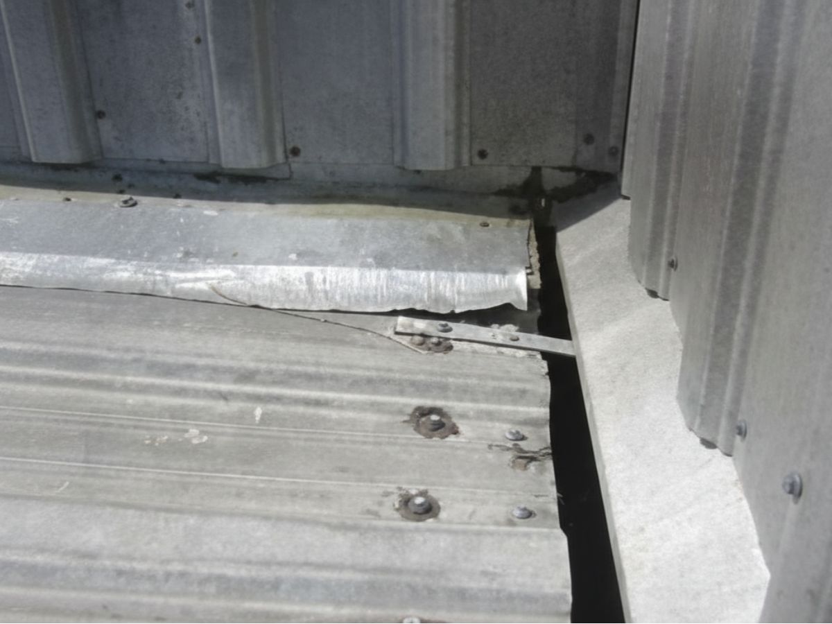 Loose or damaged flashing at metal roof transition