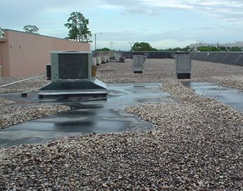 Flat roof needing new balast before repair