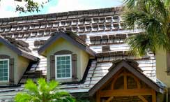 A home near Naples, Florida with a roofing job in progress by Kelly Roofing.