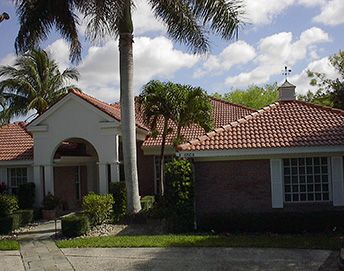 Terracotta color tile roof on light color home