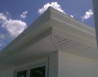 New seamless gutters on white house