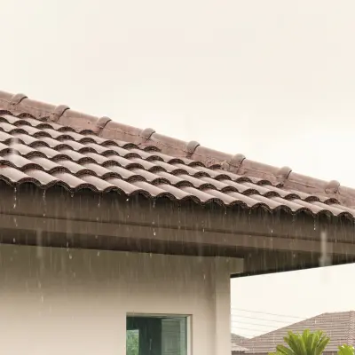 Rain coming down on a tile roof in Florida.
