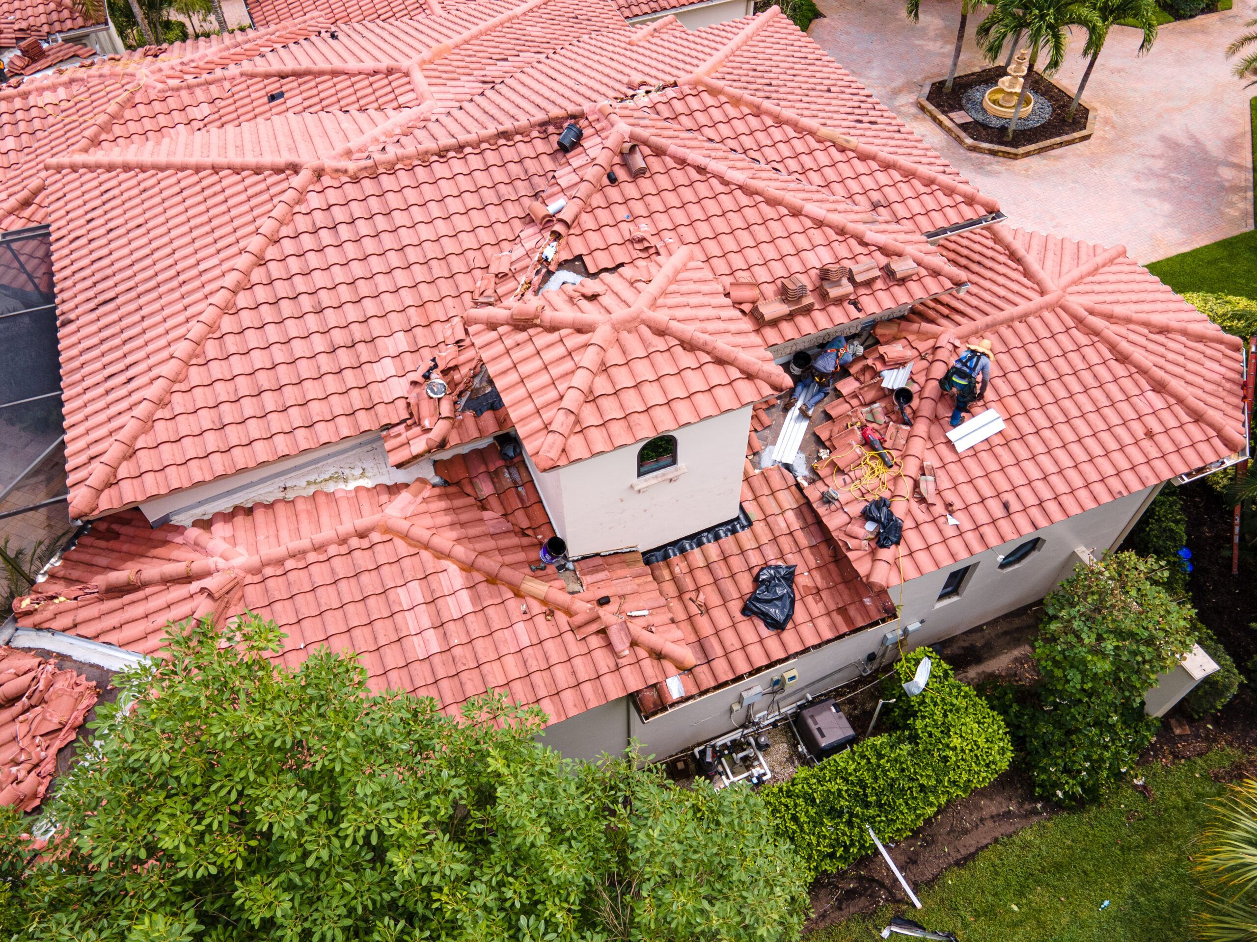 clay tile roof being repaired