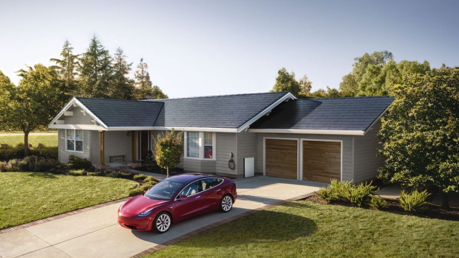 Single-story home with a newly installed dark shingle roof, landscaped yard, and red car parked in the driveway.