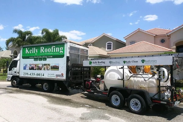 Kelly Roofing truck and Roof Rain cleaning trailer parked outside a tile-roof home